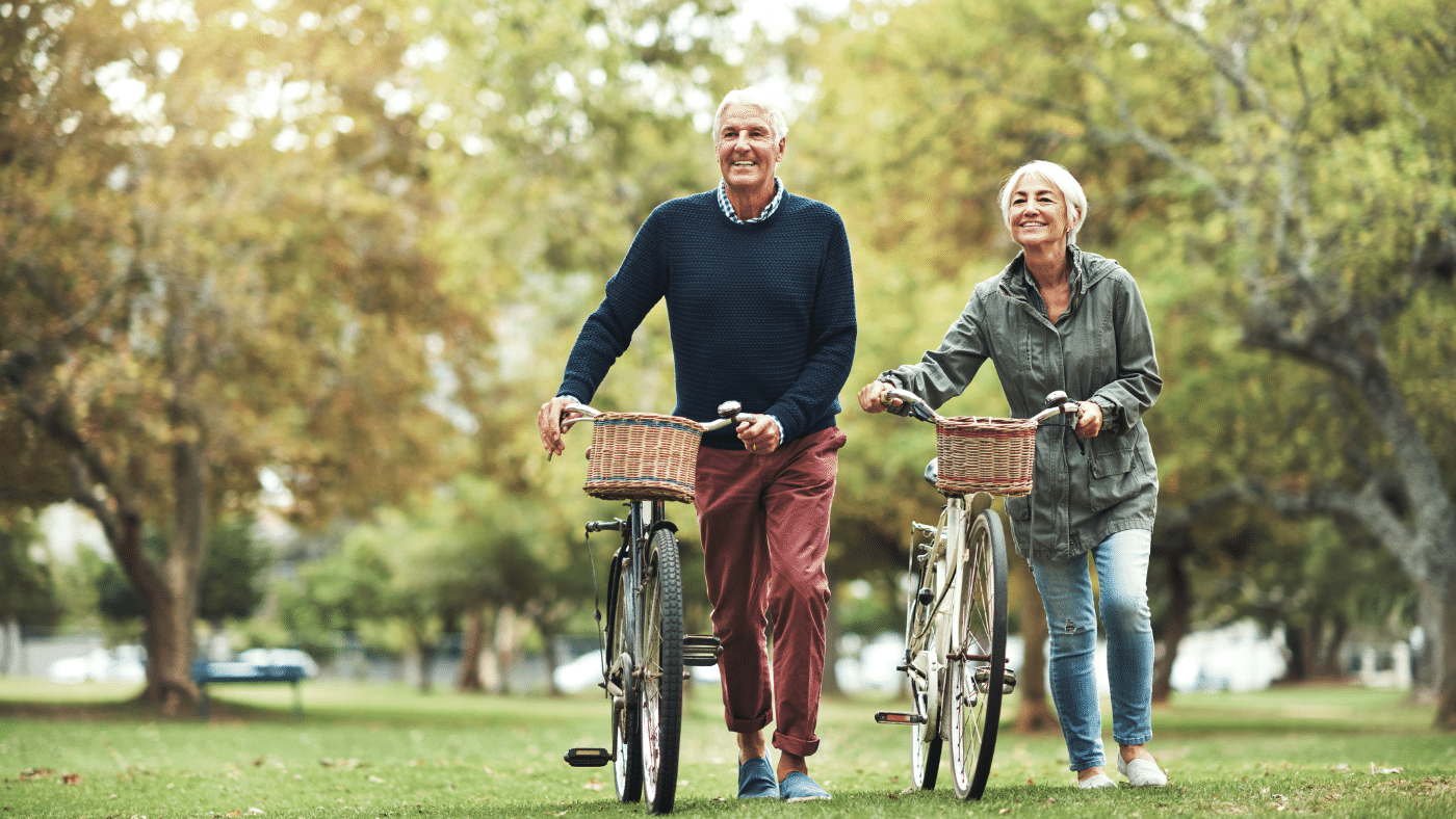 happy old couple riding bikes. Is it Actually Possible for Humans to Live Forever After All?